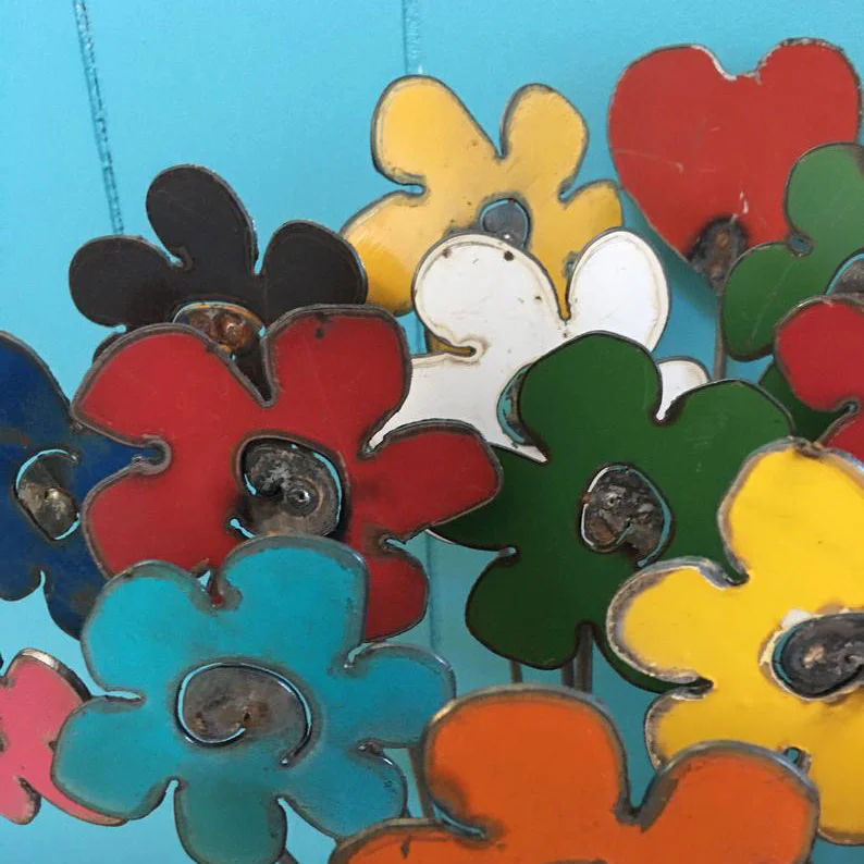 Close-up look at decorative garden art -- these rustic metal flowers make good gift ideas